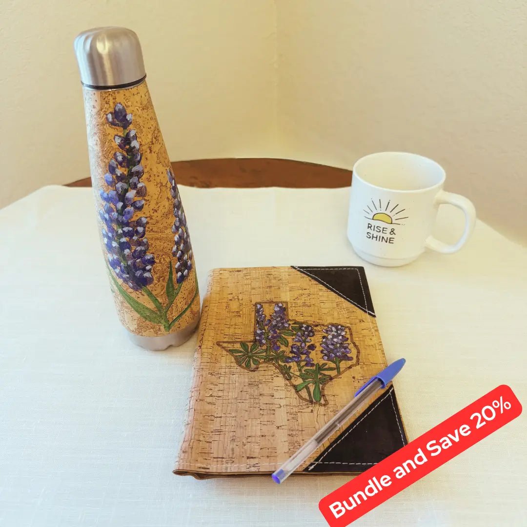 Hand painted water bottle and notebook on a table with a coffee mug
