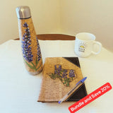 Hand painted water bottle and notebook on a table with a coffee mug