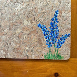Closeup of handprinted bluebonnets on cork placemat