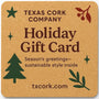 Holiday gift card with holiday decorations on a cork colored background