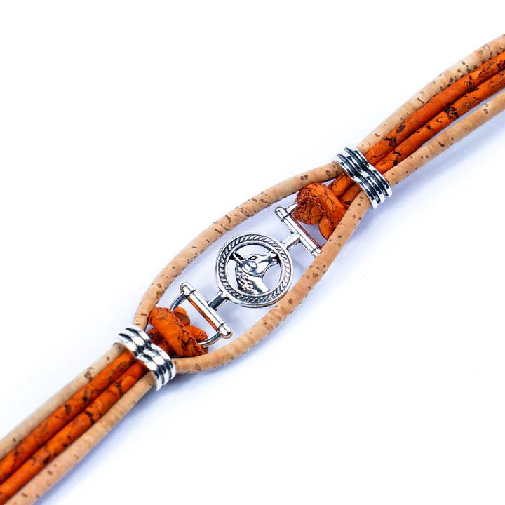 Closeup of the metal alloy horse head charm on an orange and natural colored cork bracelet.