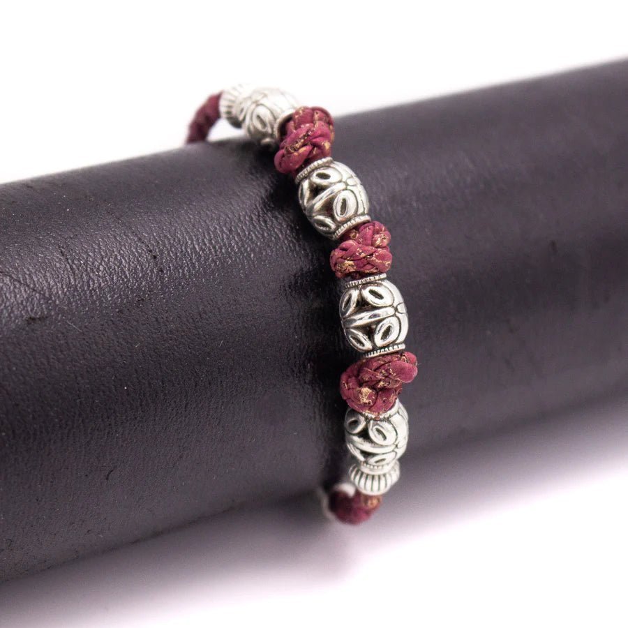 Maroon Braided Cork Bracelet with Antiqued Silver Beads on a black display from Texas Cork Company