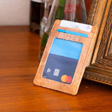 Minimalist cork card wallet with cards on a wooden table