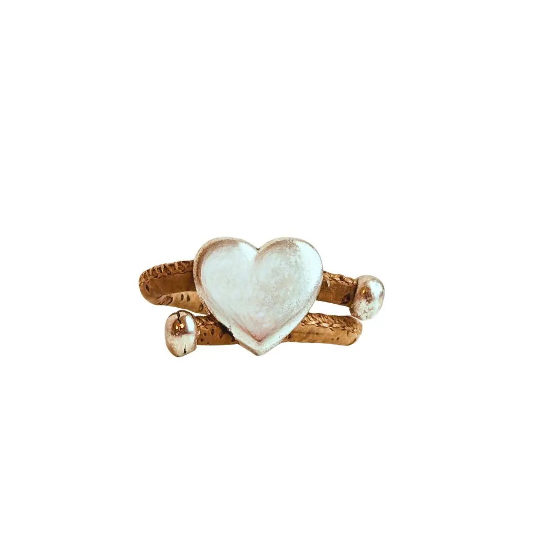 Heart-shaped silver with natural cork cord ring on a white background