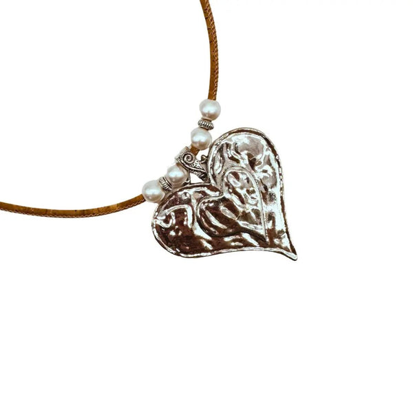 Heart-shaped silver pendant on a natural cork cord with pearl-like beads