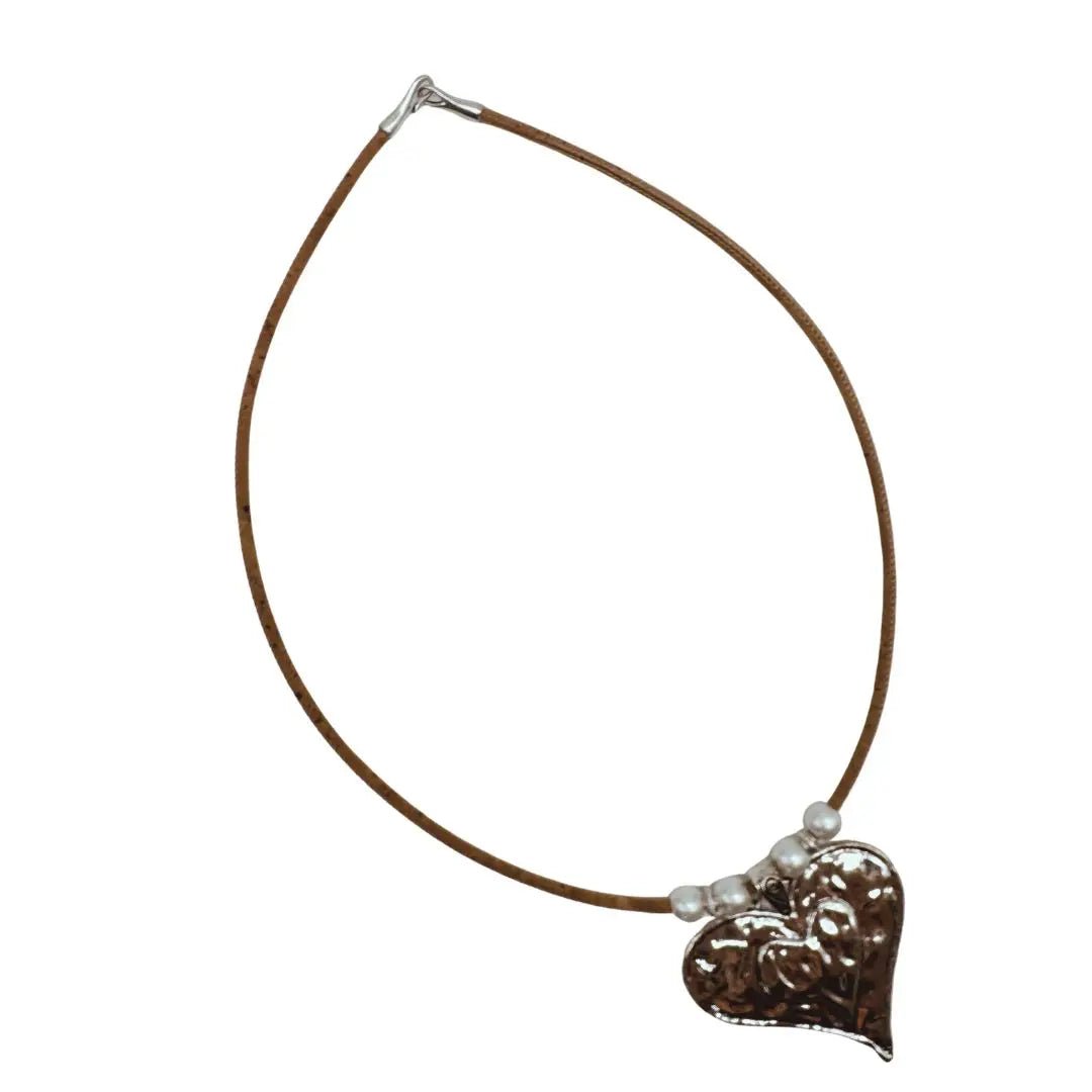Necklace of natural cork cord with a heart-shaped pendant on a white background