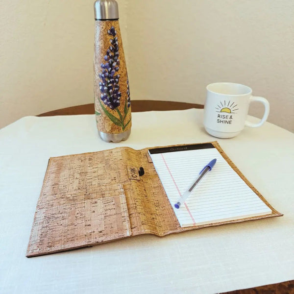 Cork Notebook with pen, mug, and water bottle on a table