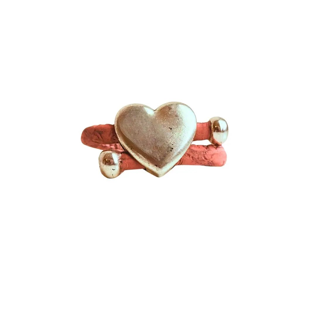 Heart-shaped silver with pink cork cord ring on a white background