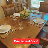 Chunky cork placemats and coasters on a dining table with flatware, plates, bowls, and wine glasses.