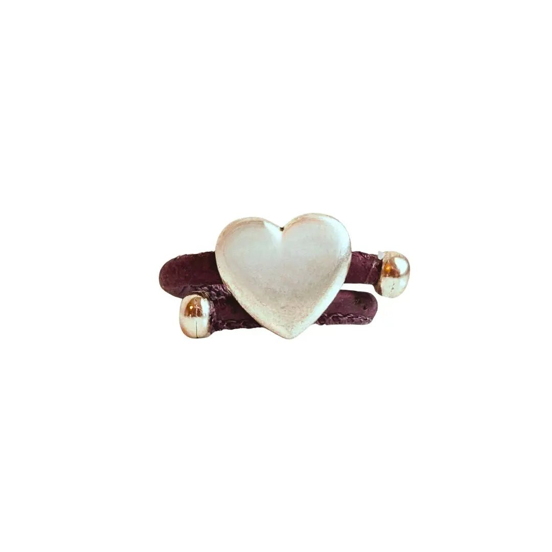 Heart-shaped silver with purple cork cord ring on a white background