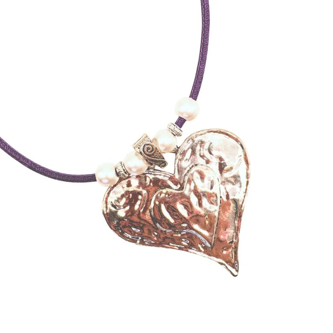 Heart-shaped silver pendant on a purple cork cord with pearl-like beads