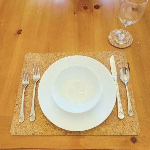 A single place setting on cork coaster and placemat.