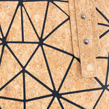 Close-up of a Taos cork bag with geometric black line pattern
