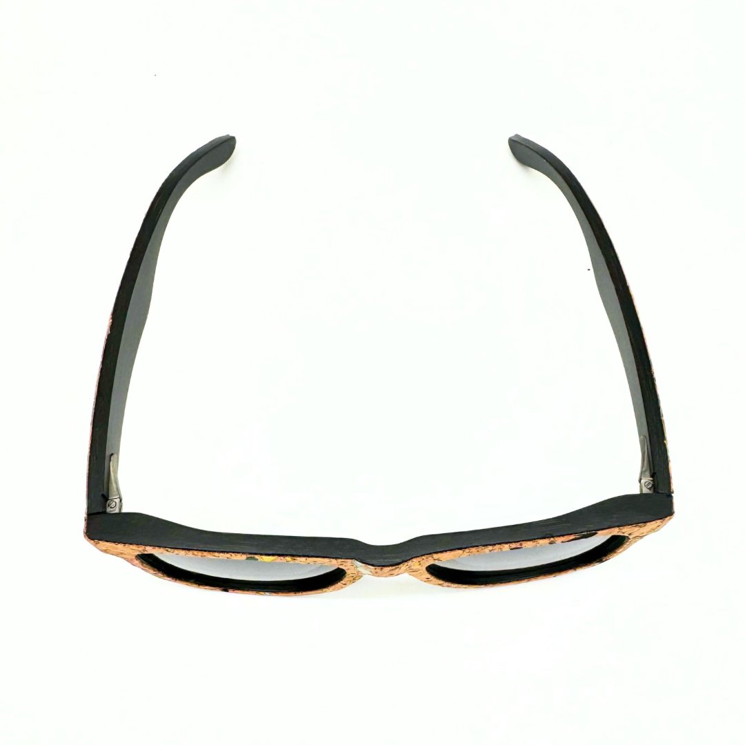 Top view of stained bamboo and cork floating sunglasses with black lenses and confetti cork by Texas Cork Company.