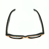 Top view of stained bamboo and cork floating sunglasses with black lenses and confetti cork by Texas Cork Company.
