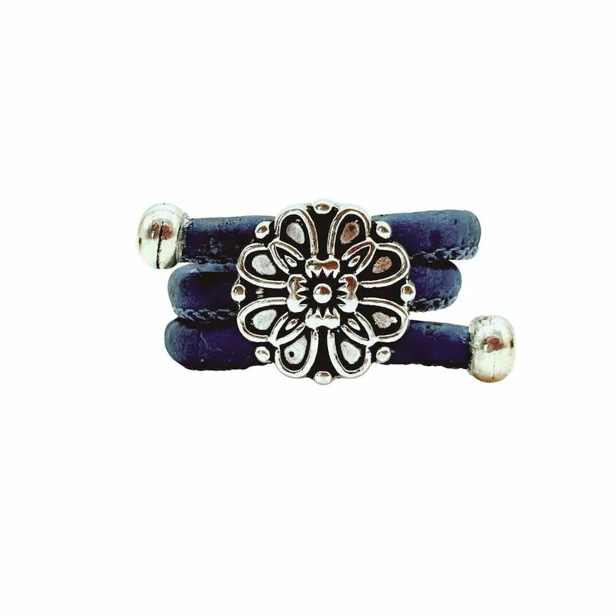Blue ring with a silver vintage floral charm on a white background