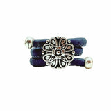 Blue ring with a silver vintage floral charm on a white background