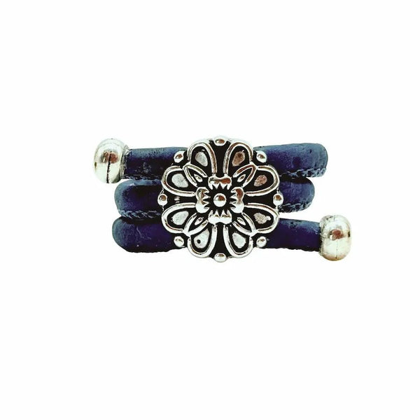 Blue ring with a silver vintage floral charm on a white background