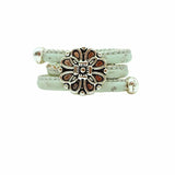 Mint cork ring with a silver vintage floral charm on a white background