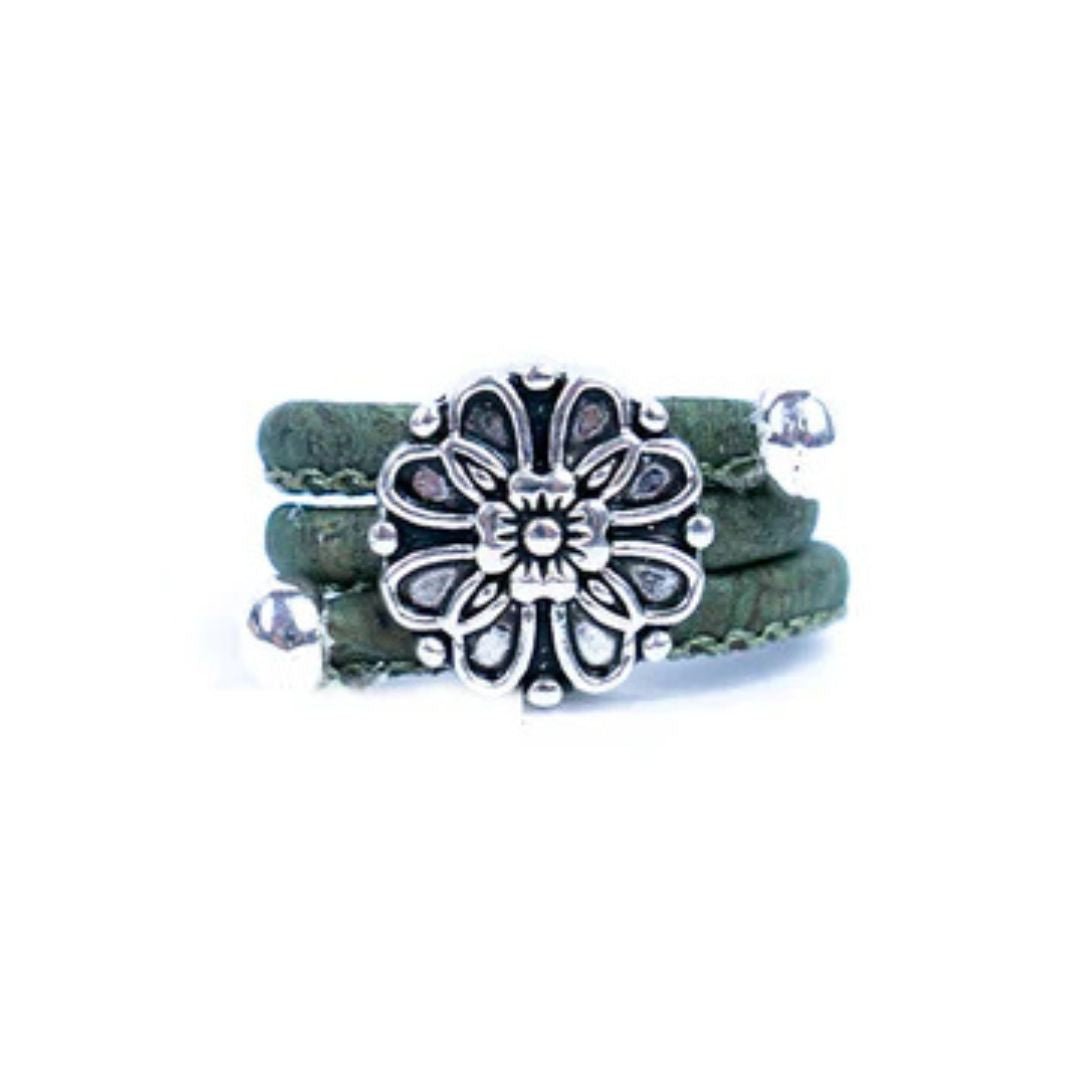 Olive Green cork ring with a silver vintage floral charm on a white background
