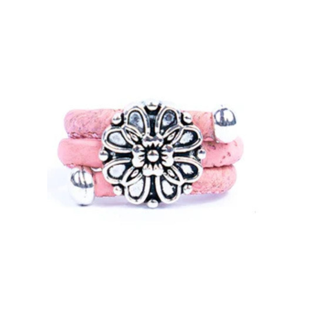 Pink cork ring with a silver vintage floral charm on a white background