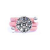 Pink cork ring with a silver vintage floral charm on a white background