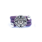 Purple cork ring with a silver vintage floral charm on a white background