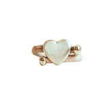 Heart-shaped silver with white cork cord ring on a white background