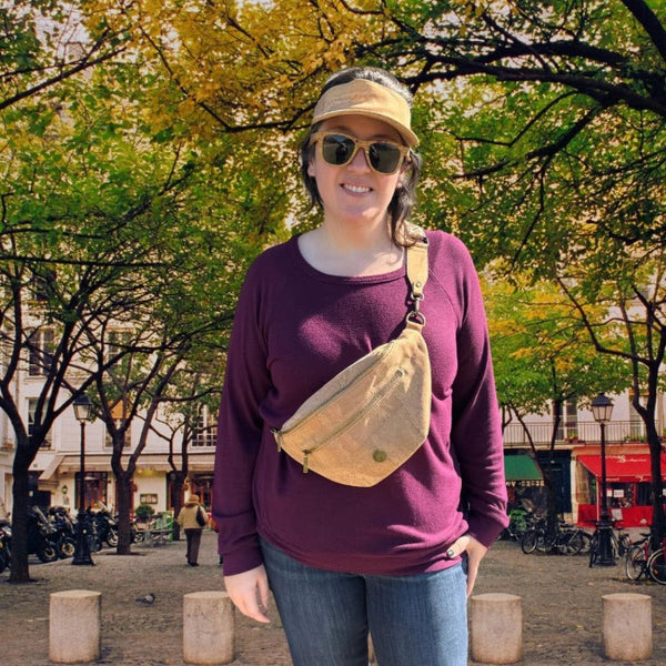Woman wearing cork sling fanny pack as cross body bag