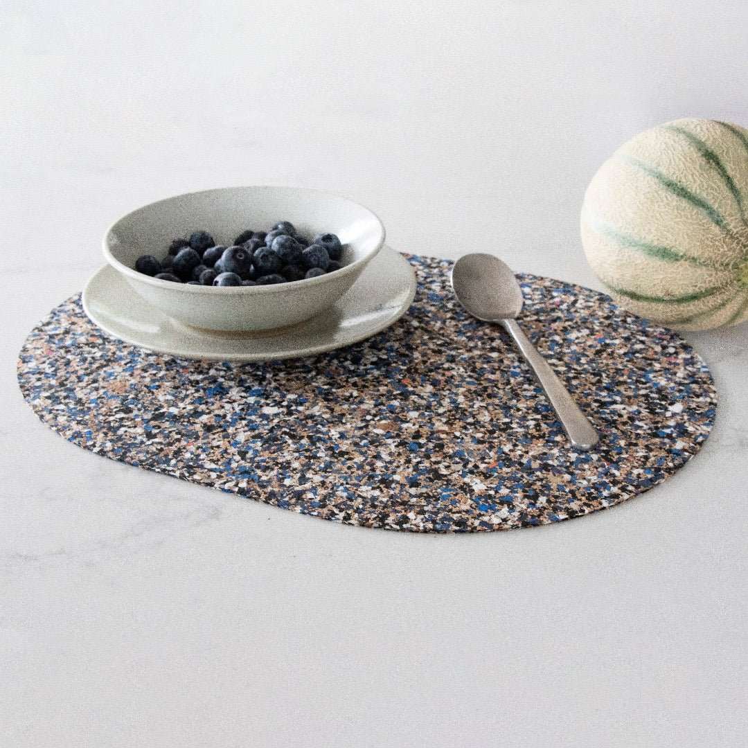 Oval Beach Clean Placemats in cuse with melon and bowl of blueberries -BC-OVAL-PM - Texas Cork Company